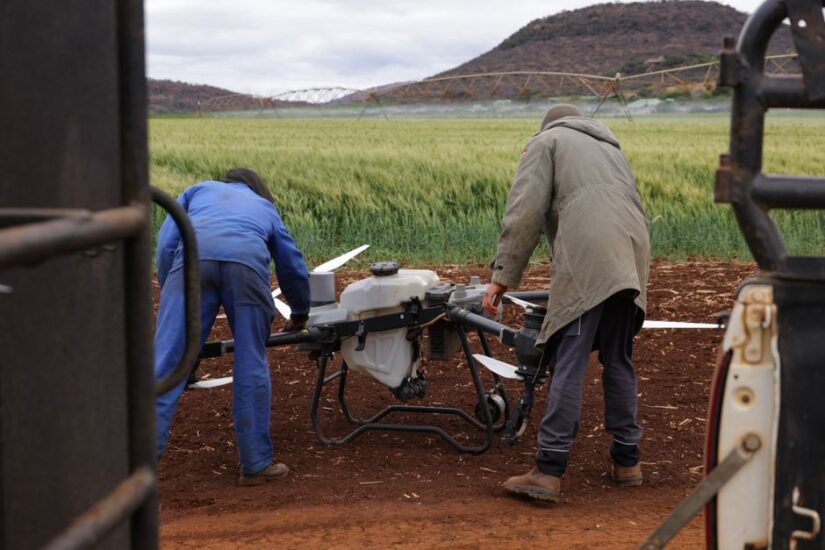 Drone equipped with LiDAR technology surveying power lines in rugged terrain for utility inspections.